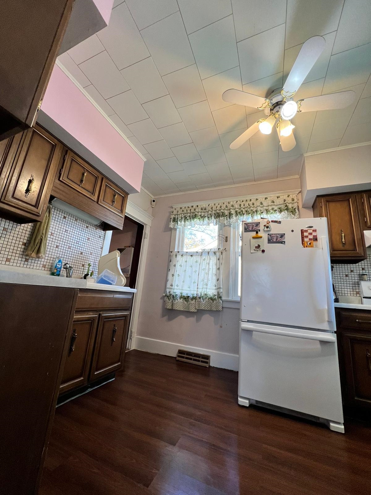 425 North Main Street Stockton, IL 61085 - Photo 3 of 20 a kitchen with kitchen island a wooden floor and a refrigerator