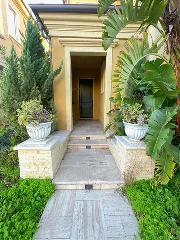 a view of a house with potted plants