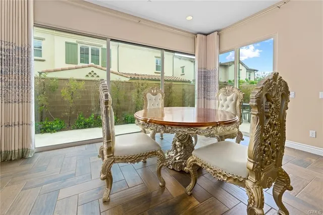 a dining room with furniture a chandelier and wooden floor