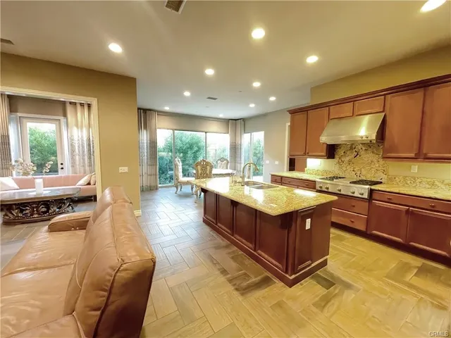 a kitchen with stainless steel appliances granite countertop a stove and a sink