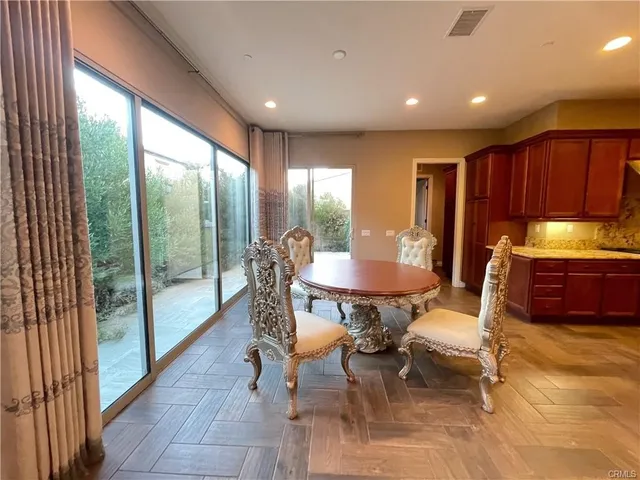 a dining room with furniture and wooden floor
