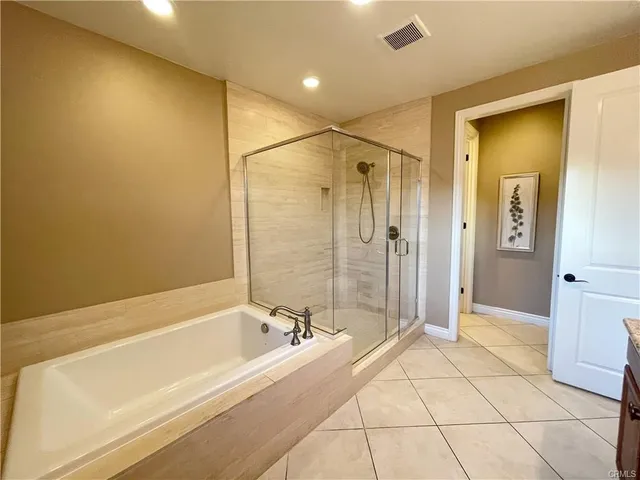a spacious bathroom with a bathtub and a shower