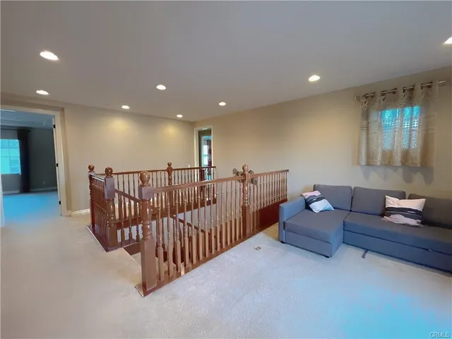 a living room with furniture and a ceiling fan