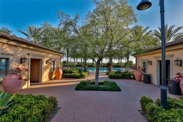 a view of a house with a yard and potted plants