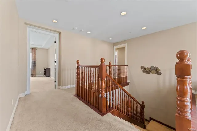 a view of a hallway with a large window and stairs