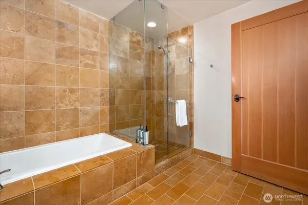 a bathroom with a bathtub and shower