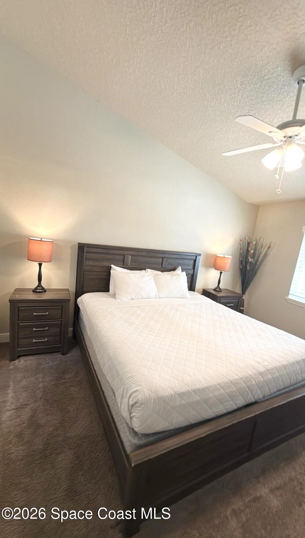 2709 Cutlass Point Lane, Unit 103 Merritt Island, FL 32953 - Photo 11 of 31 a bedroom with a bed and a night stand