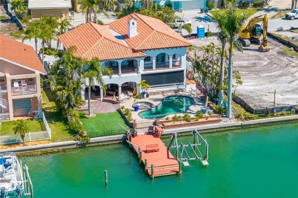 an aerial view of a house with swimming pool garden and patio