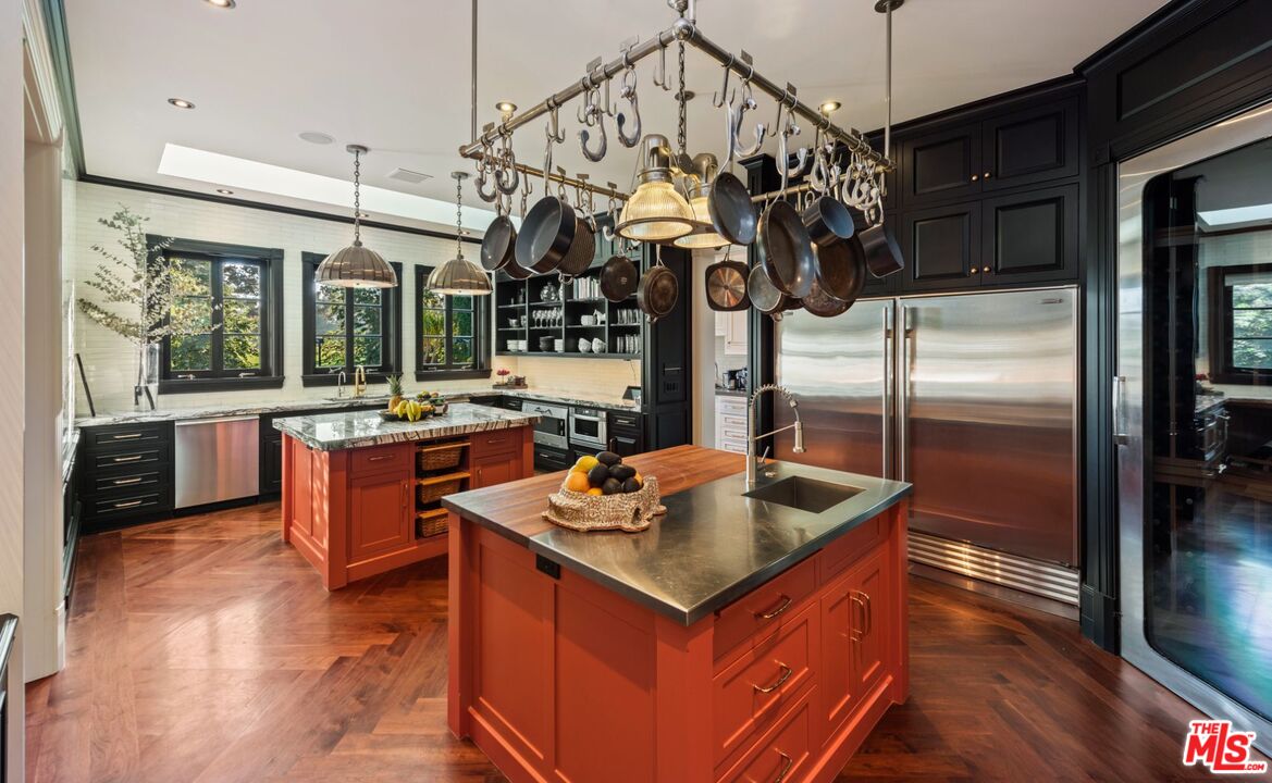 9966 Sunset Boulevard Beverly Hills, CA 90210 - Photo 19 of 58 a kitchen with stainless steel appliances granite countertop a sink a counter space and a window