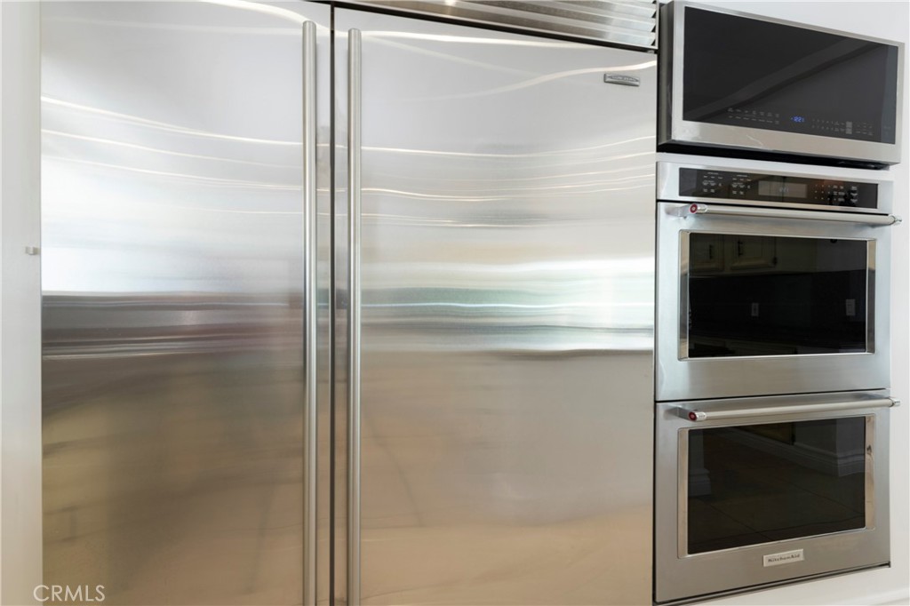 16379 Meadow Ridge Road West Encino, CA 91436 - Photo 11 of 40 a kitchen with a refrigerator and microwave