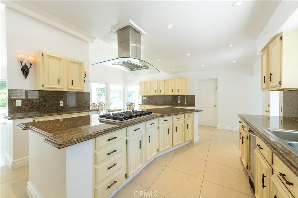 16379 Meadow Ridge Road West Encino, CA 91436 - Photo 13 of 40 a kitchen with granite countertop a sink stove and cabinets