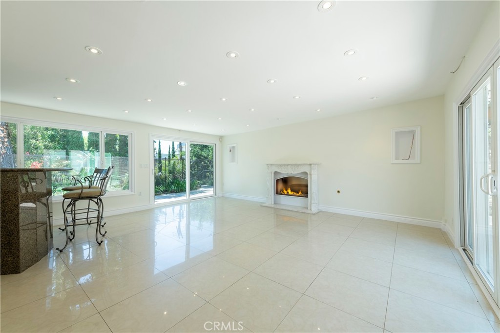 16379 Meadow Ridge Road West Encino, CA 91436 - Photo 15 of 40 a view of a living room a patio and a garden
