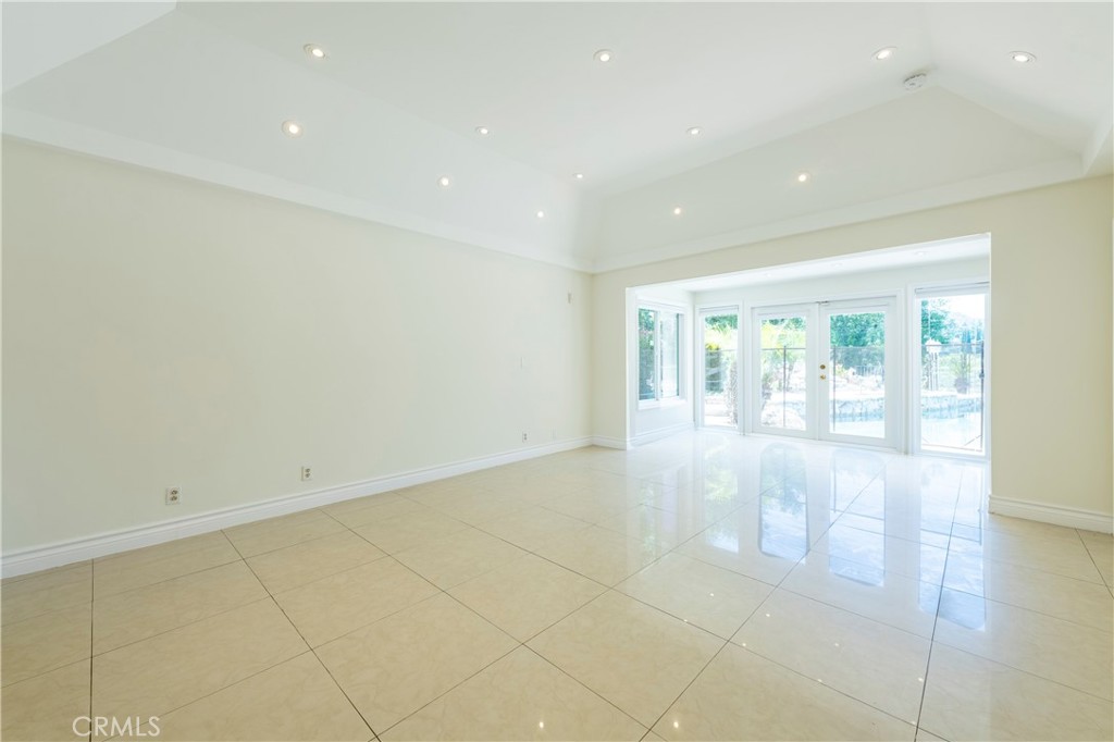 16379 Meadow Ridge Road West Encino, CA 91436 - Photo 19 of 40 a view of an empty room with wooden floor and a window