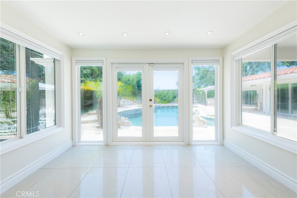 16379 Meadow Ridge Road West Encino, CA 91436 - Photo 20 of 40 a view of an empty room with wooden floor and a window