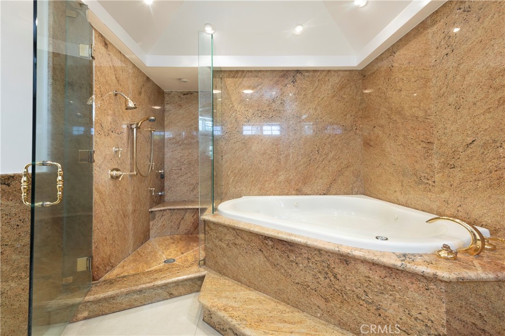 16379 Meadow Ridge Road West Encino, CA 91436 - Photo 23 of 40 a bathroom with a bathtub and a shower