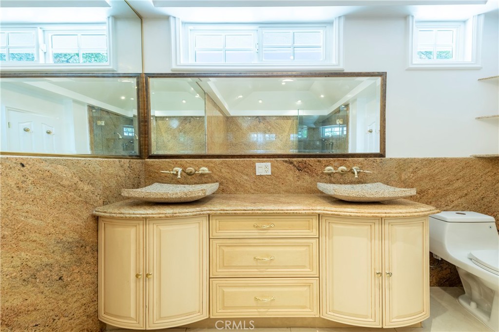 16379 Meadow Ridge Road West Encino, CA 91436 - Photo 24 of 40 a bathroom with a sink and a mirror