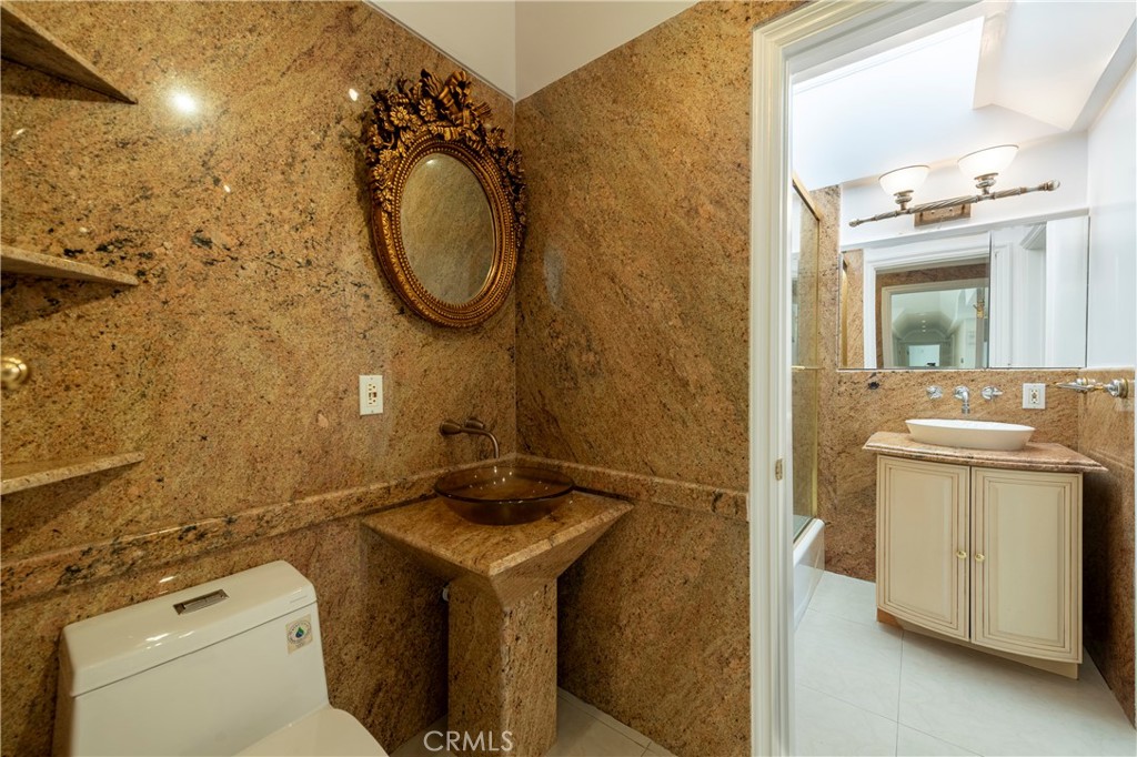 16379 Meadow Ridge Road West Encino, CA 91436 - Photo 26 of 40 a bathroom with a sink and a mirror