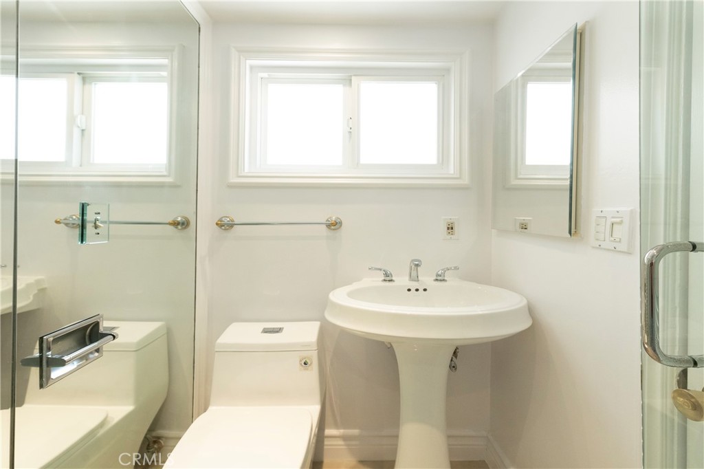 16379 Meadow Ridge Road West Encino, CA 91436 - Photo 30 of 40 a bathroom with a sink a toilet and a mirror