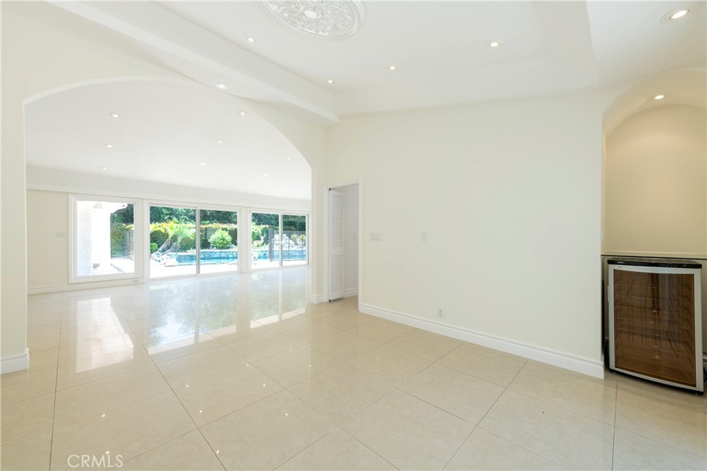 16379 Meadow Ridge Road West Encino, CA 91436 - Photo 7 of 40 an empty room with wooden floor and a window