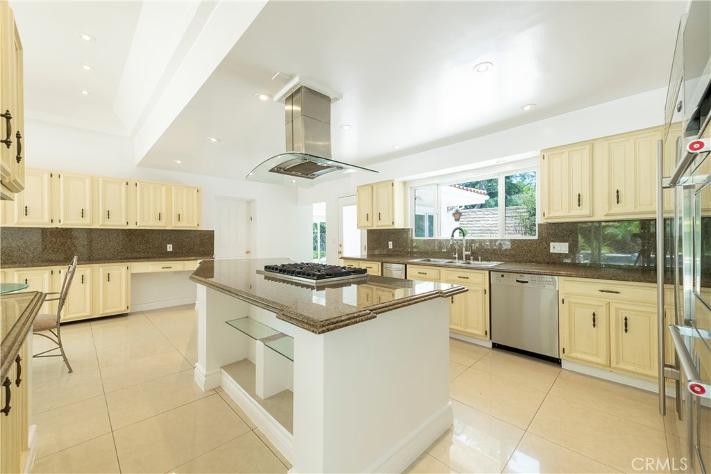 16379 Meadow Ridge Road West Encino, CA 91436 - Photo 8 of 40 a kitchen with stainless steel appliances granite countertop a sink and cabinets