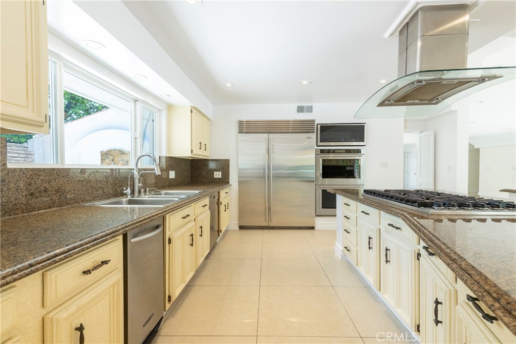 16379 Meadow Ridge Road West Encino, CA 91436 - Photo 9 of 40 a large kitchen with stainless steel appliances granite countertop a sink and a stove