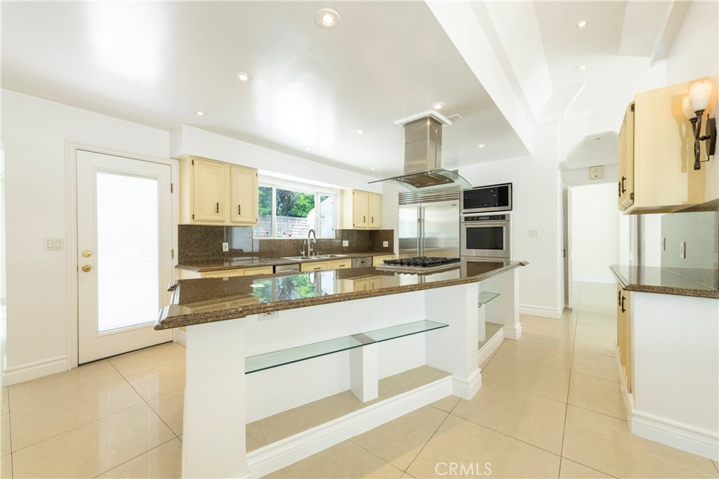 16379 Meadow Ridge Road West Encino, CA 91436 - Photo 10 of 40 a large kitchen with granite countertop a sink and cabinets