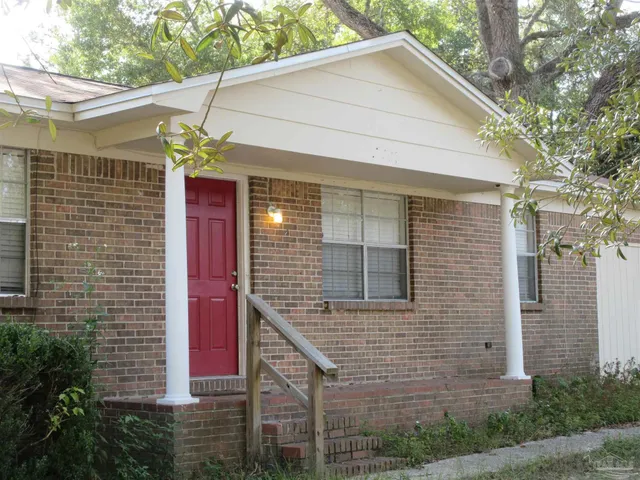 a view of a house with brick walls