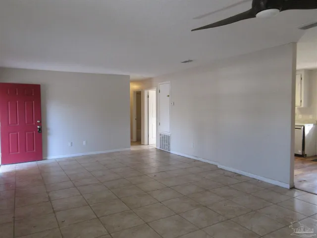 a view of an empty room and a window