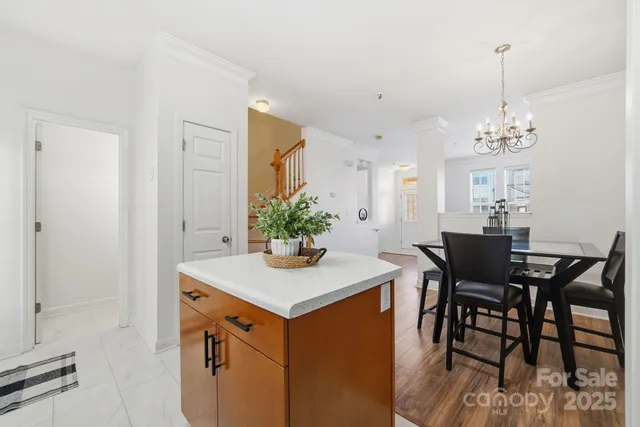 a view of a dining room with furniture and chandelier