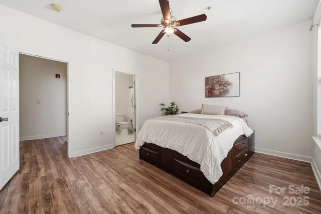 a bedroom with a bed and a painting on the wall