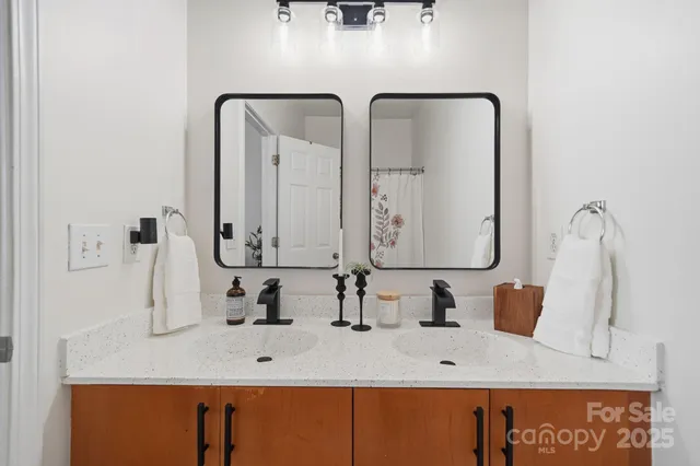 a bathroom with double vanity sink and mirror