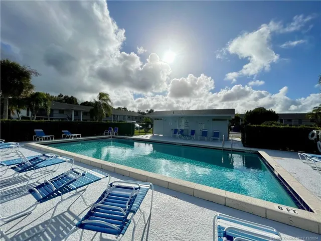 a view of a swimming pool with a yard