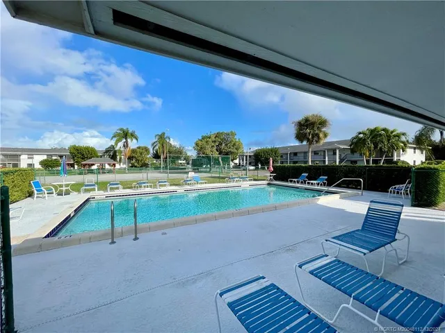 a view of swimming pool with outdoor seating