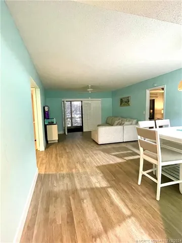 a room with a white stove top oven and white kitchen
