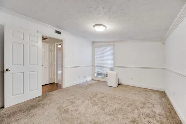 an empty room with closet and natural light