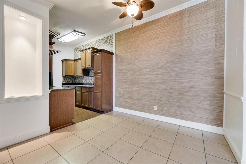 2627 Douglas Avenue, Unit 205 Dallas, TX 75219 - Photo 6 of 17 a kitchen with stainless steel appliances a refrigerator and a stove top oven