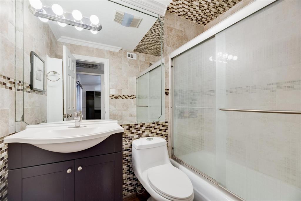 2627 Douglas Avenue, Unit 205 Dallas, TX 75219 - Photo 10 of 17 a bathroom with a sink a toilet and shower