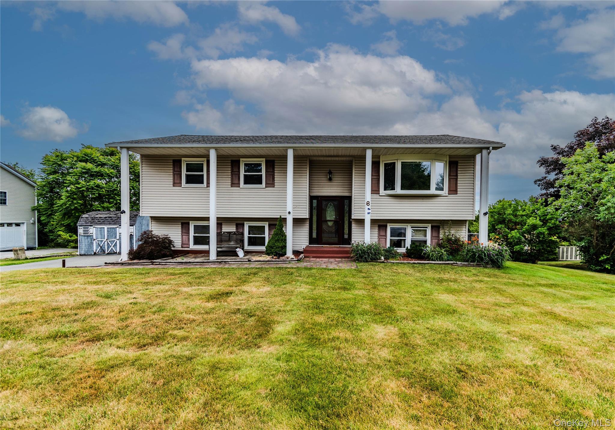 6 Bates Circle Florida, NY 10921 - Photo 1 of 50 Split-level residence featuring vinyl siding, a covered entry, and a prominent bay window