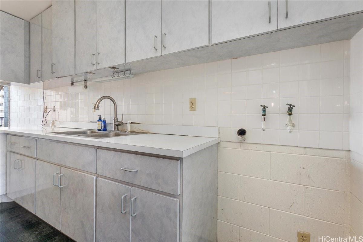 1420 Victoria Street, Unit 1301 Honolulu, HI 96822 - Photo 11 of 20 a kitchen with white cabinets