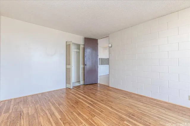a view of a room with wooden floor