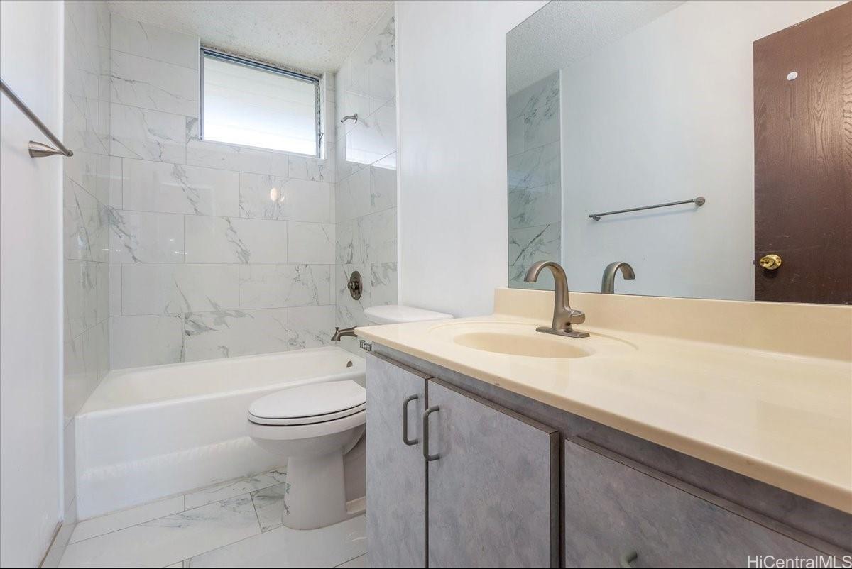 1420 Victoria Street, Unit 1301 Honolulu, HI 96822 - Photo 18 of 20 a bathroom with a sink a toilet and shower