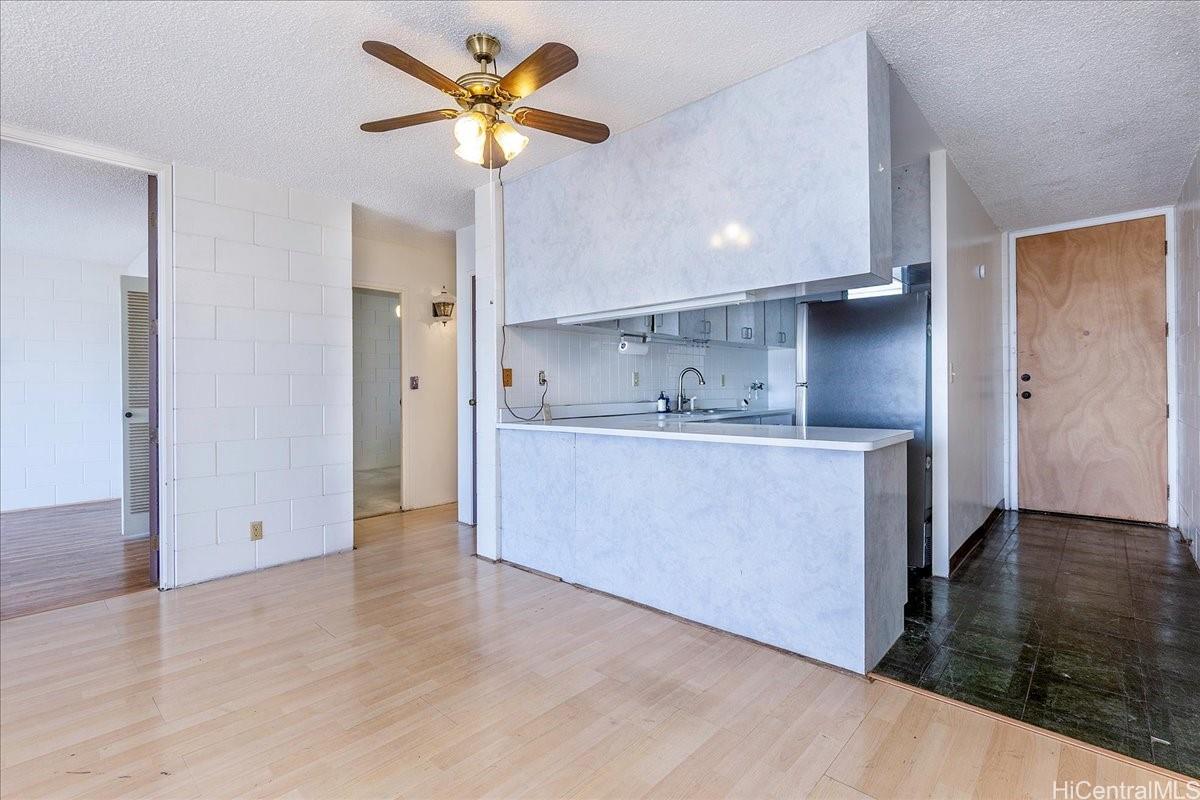 1420 Victoria Street, Unit 1301 Honolulu, HI 96822 - Photo 6 of 20 a view of kitchen with stainless steel appliances granite countertop a refrigerator a sink and a stove