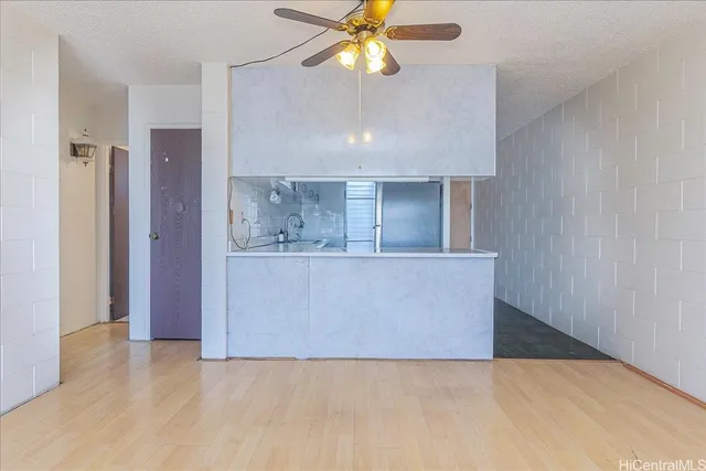 a view of kitchen and hallway with a chandelier