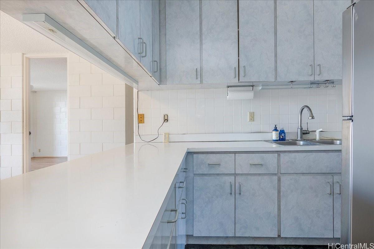 1420 Victoria Street, Unit 1301 Honolulu, HI 96822 - Photo 8 of 20 a kitchen with a sink and cabinets