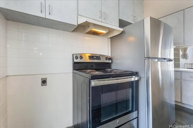 a stove top oven sitting inside of a kitchen