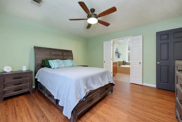 a bed room with a bed and a chandelier