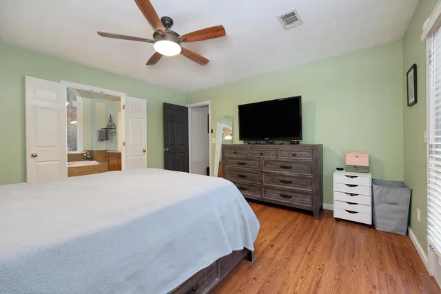 a bedroom with a bed and flat screen tv