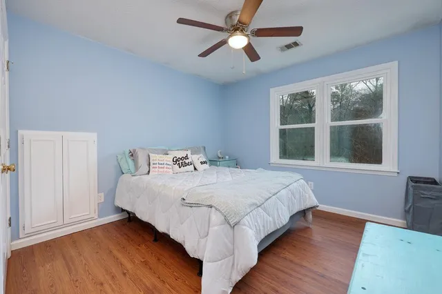 a bedroom with a large bed and a large window