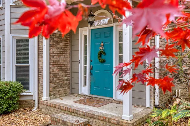 a front view of a house with a tree