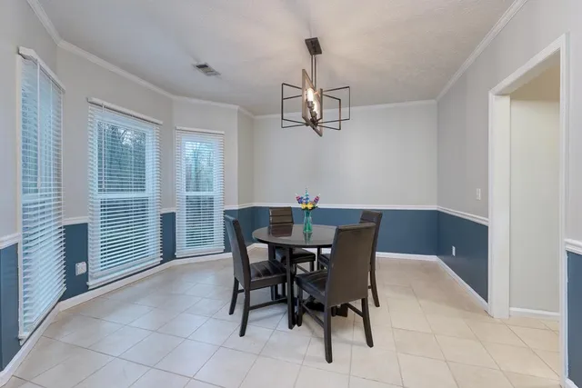 a view of a dining room with furniture and chandelier